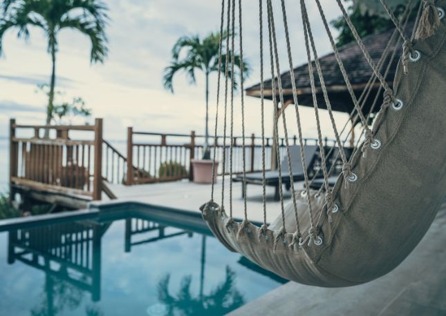 A view of a hammock near a private plunge pool in an exotic destination.