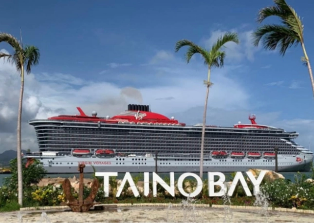 A side view of the Virgin Voyage cruise ship at port Taino Bay