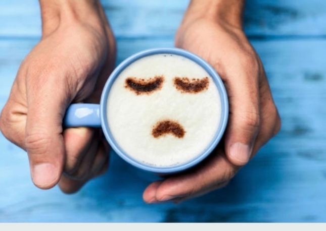 Coffee mug with unhappy face, Blue Monday