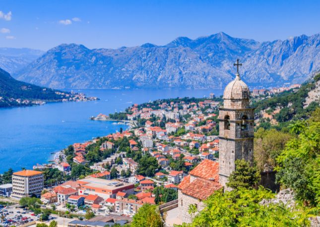 Explore Montenegro's history, spectacular landscapes, and top highlights on this scenic motorcoach sightseeing tour. Departing Kotor you'll drive along steep slopes to Lovcen Mountain. Your first stop is the picturesque Village of Njegusi, where you'll savor smoked ham, cheese, homemade bread, and wine.
