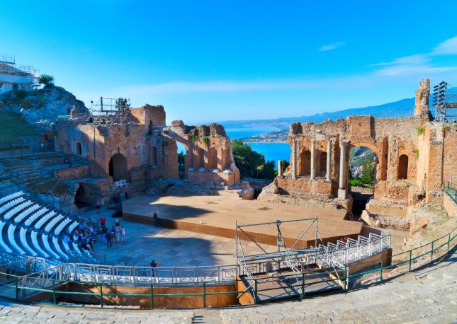 Stroll along Corso Umberto, enjoy a cappuccino at a local café, and visit the iconic Greek Theatre for stunning views of Mt. Etna’s snow-capped peak. Next, drive south along scenic roads winding around Mt. Etna’s slopes, passing Giarre and Santa Venerina.