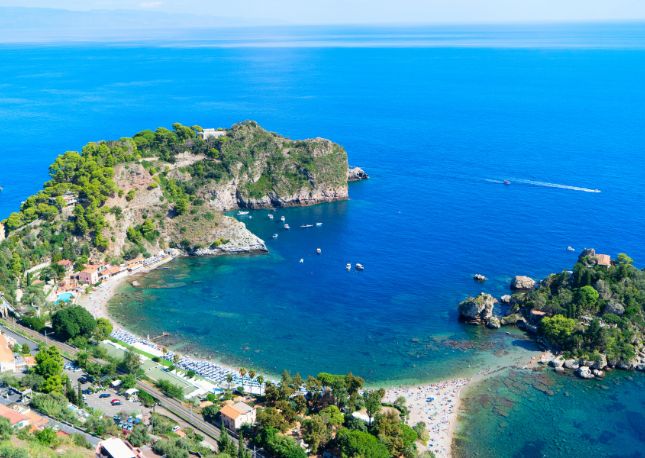Discover the charming village of Taormina and enjoy a scenic cruise to the Coral Grotto and Lovers Grotto. Taormina overlooks the breathtaking Bay of Naxos, perched 700 feet above sea level from its stunning rocky promontory.