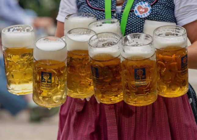 Waitress holding multiple beers for October Fest in Germany.