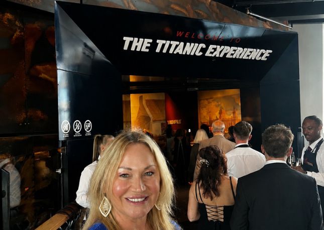 Woman standing in front of the Titanic Museum entrance in Belfast, Northern Ireland.